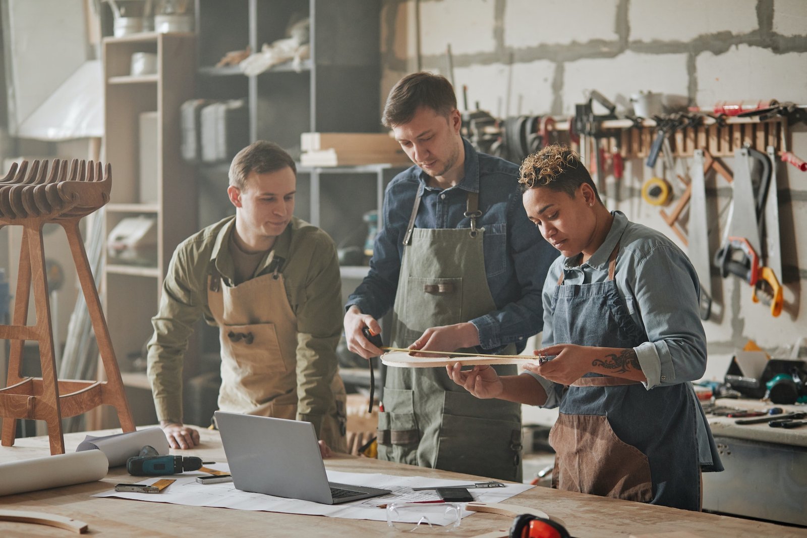 group of carpenters collaborating in shop